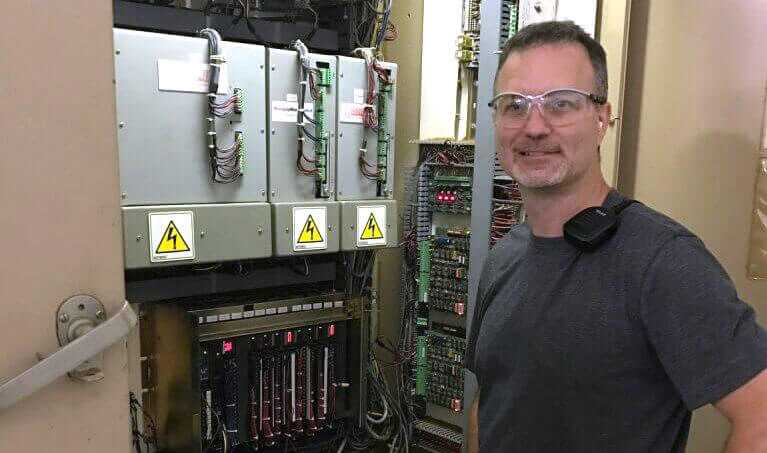 Worker wearing 3M BX Dual Reader Safety Glasses