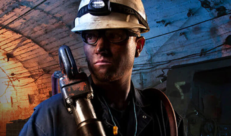 Worker wearing anti-fog safety glasses and a hard hat