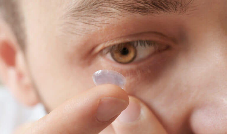 Person inserting a contact lens