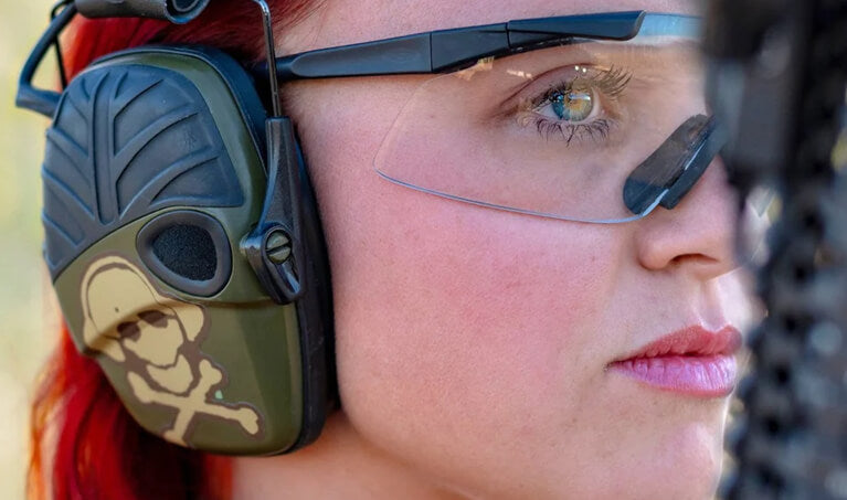Woman wearing Noisefighters SightLines Gel Ear Pads with Howard Leight Impact Sport Earmuffs