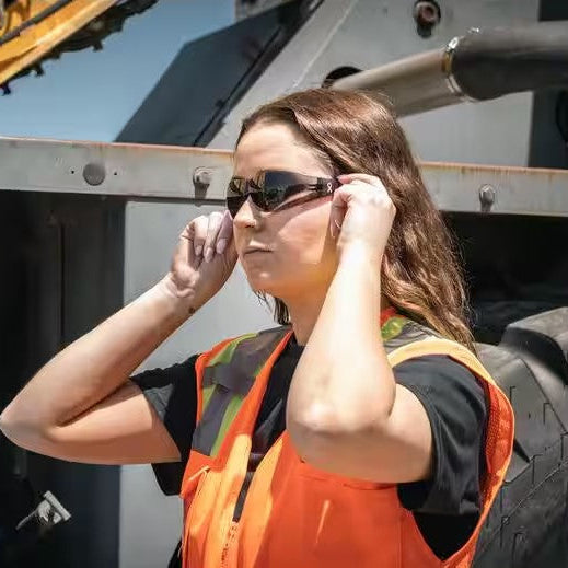 Bouton Eva Women's Safety Glasses with Pink Frames and Gray Lenses worn outdoors