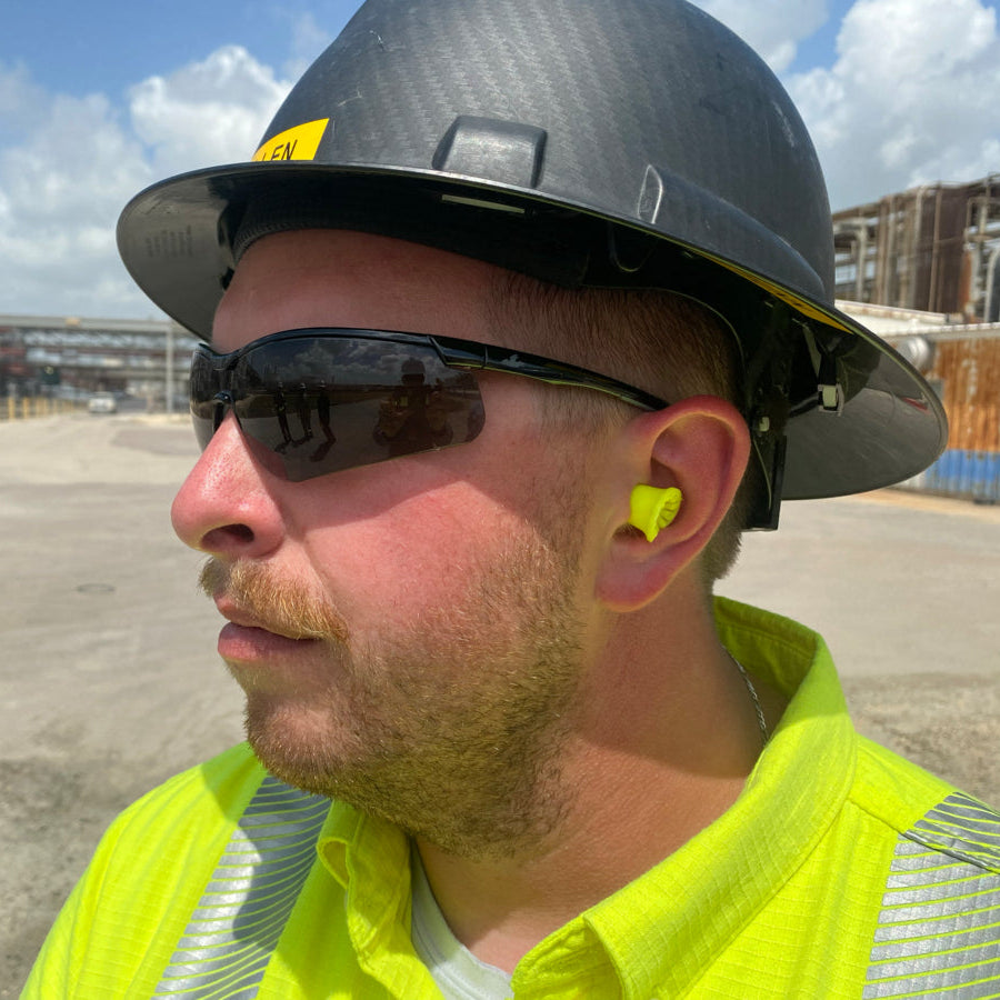 MCR Safety Klondike KD7 Safety Glasses KD712AFworn on a construction site with a hard hat and earplugs