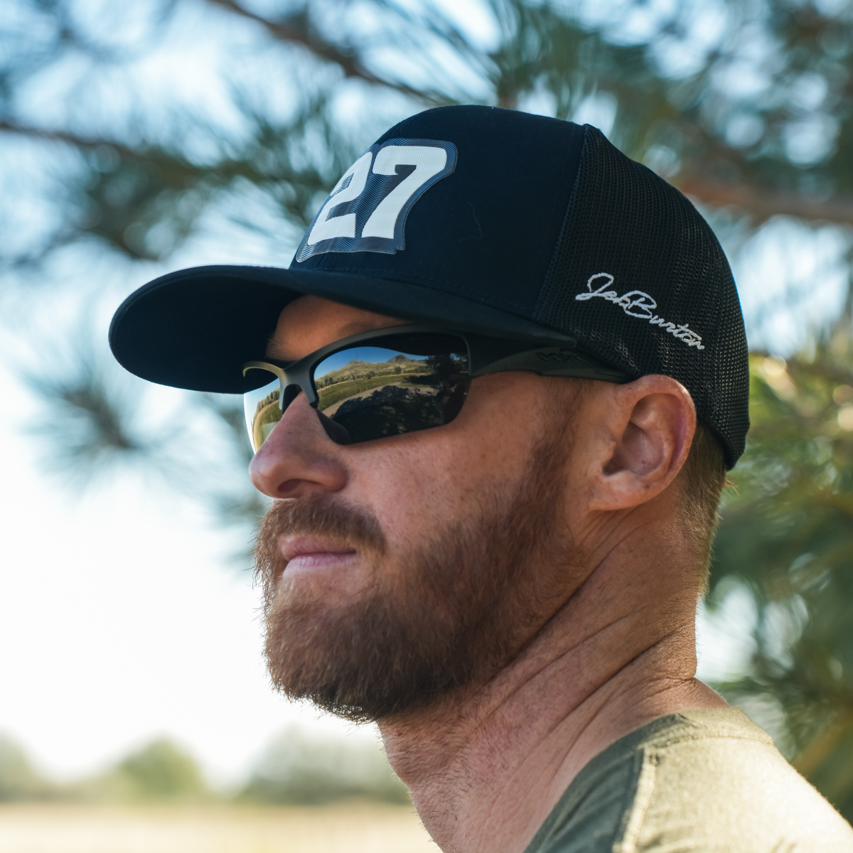 A man wearing a black cap with Wiley X Valor Sunglasses, outdoors.