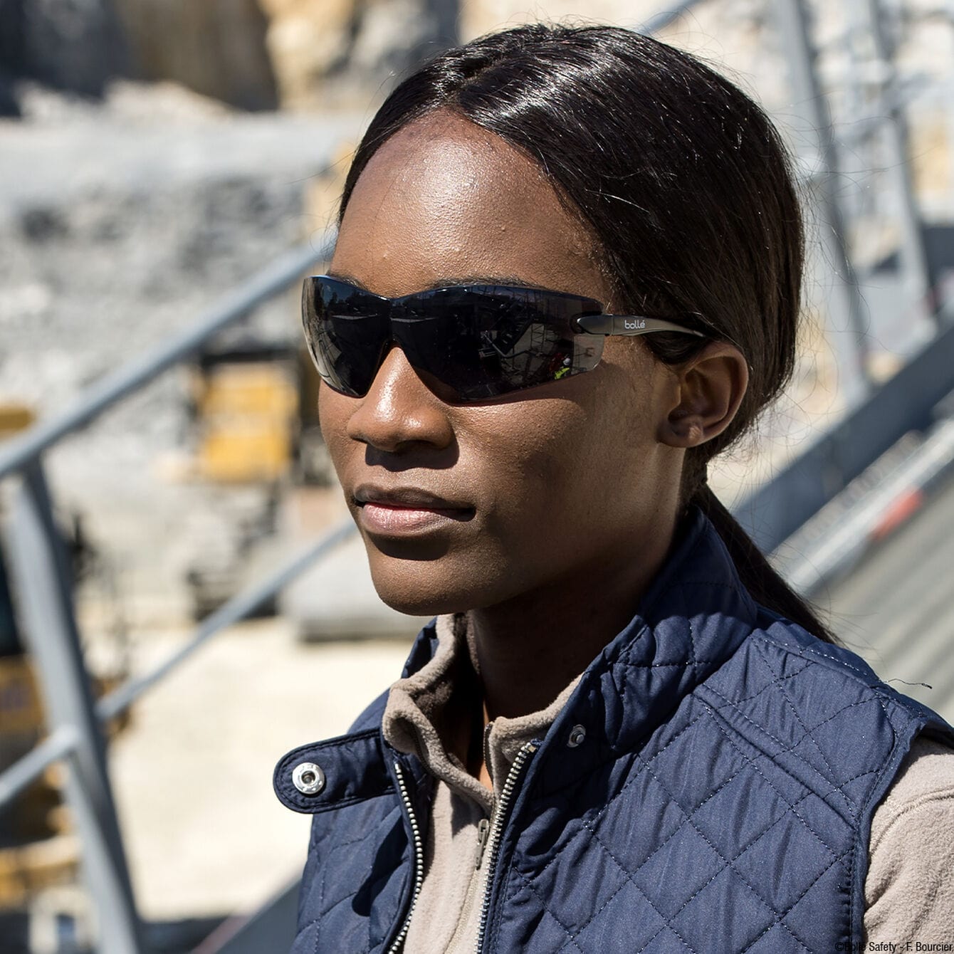 Bolle Cobra Safety Glasses with Black Temples and Smoke Anti-Fog Lens worn on the jobsite.