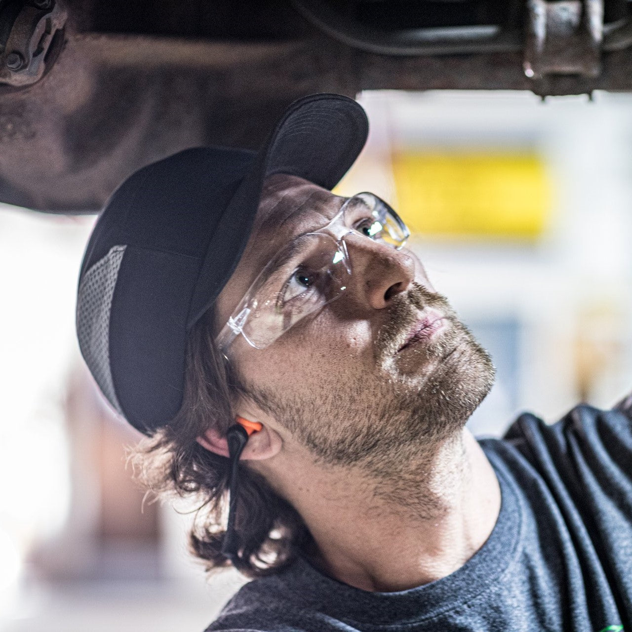 Pyramex Ztek S2510ST Safety Glasses with Clear Anti-Fog Lenses worn by a mechanic