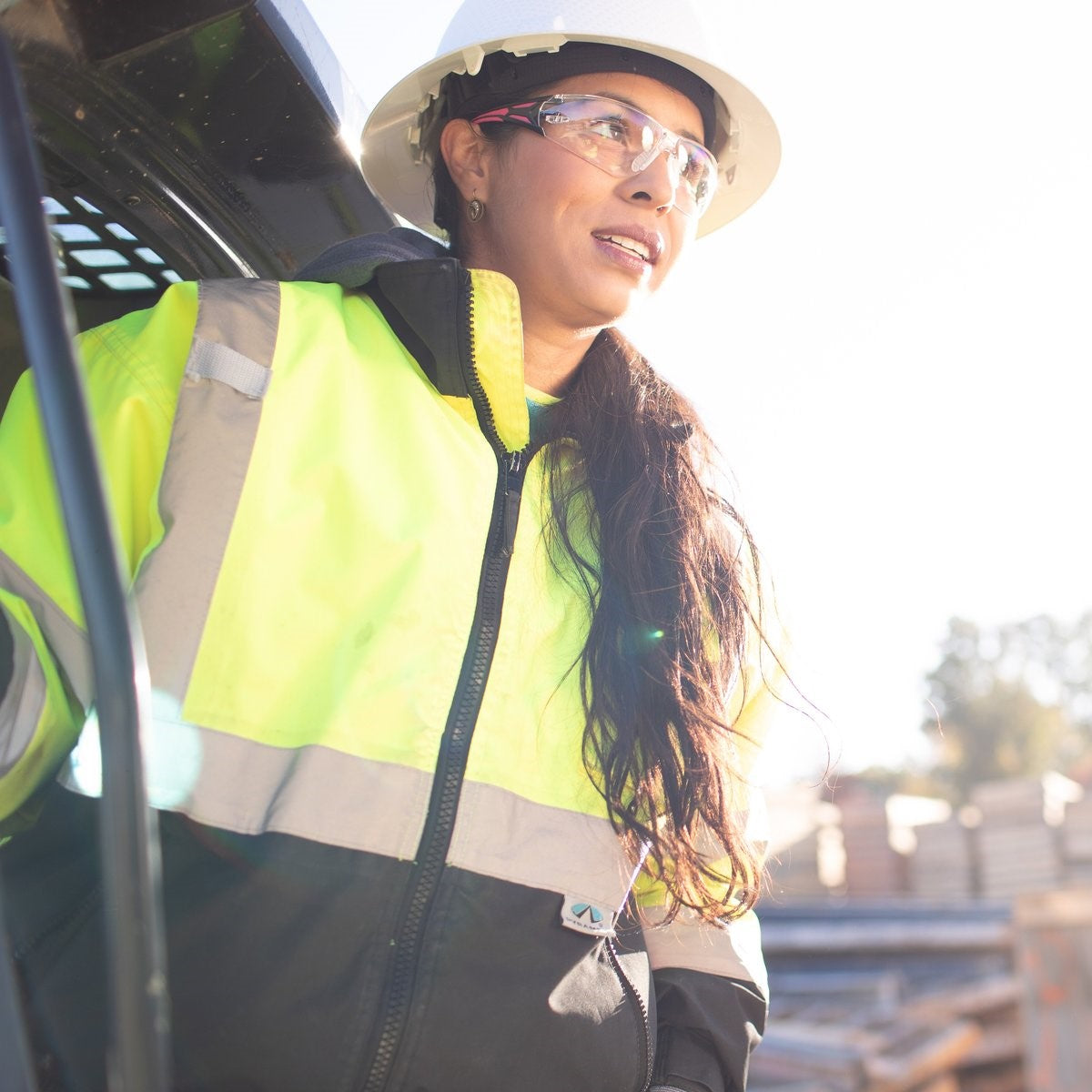 Pyramex Endeavor Plus Safety Glasses Pink Temples with Clear Lenses worn by a construction worker