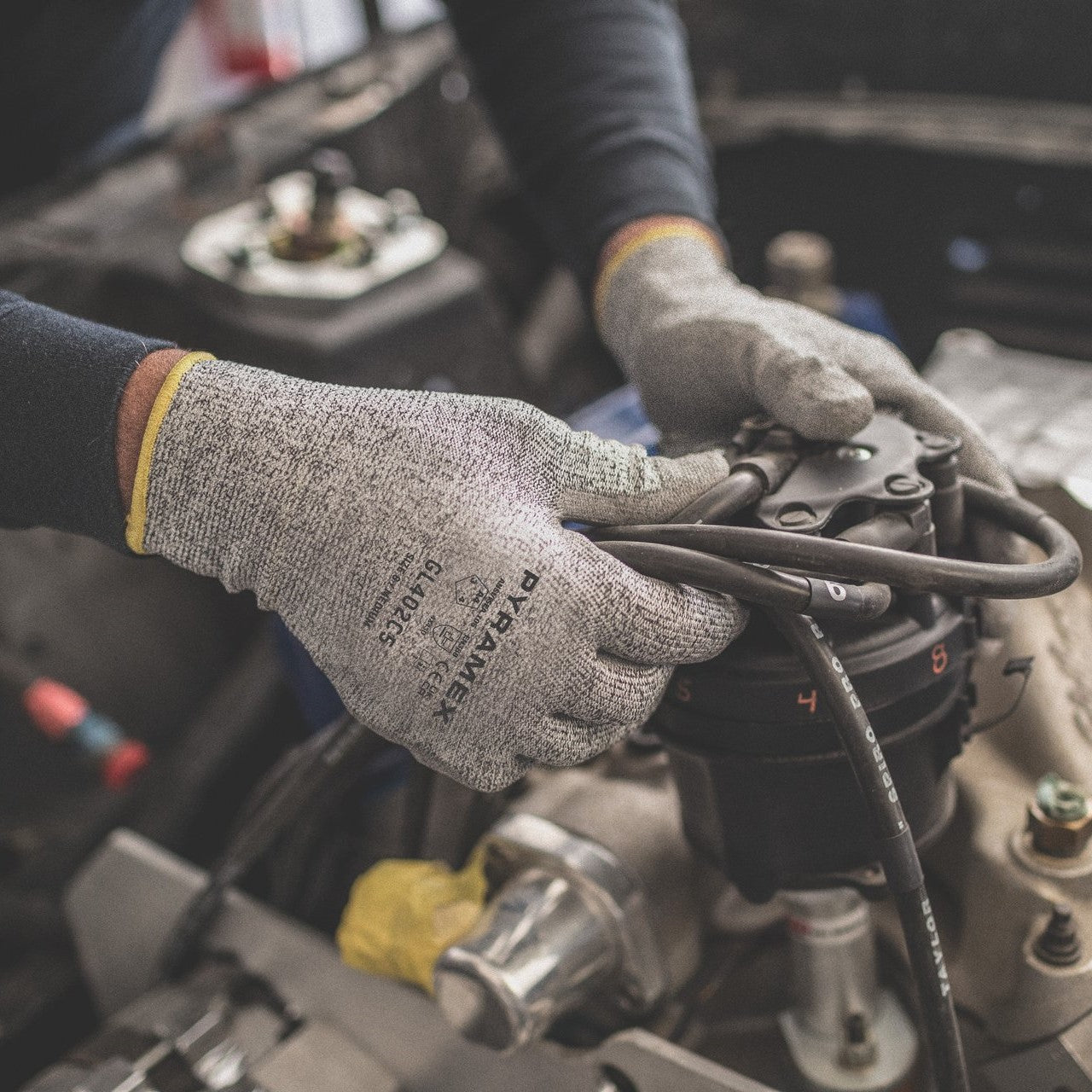 Pyramex GL402C5 Polyurethane Cut-Resistant Work Gloves worn by a mechanic