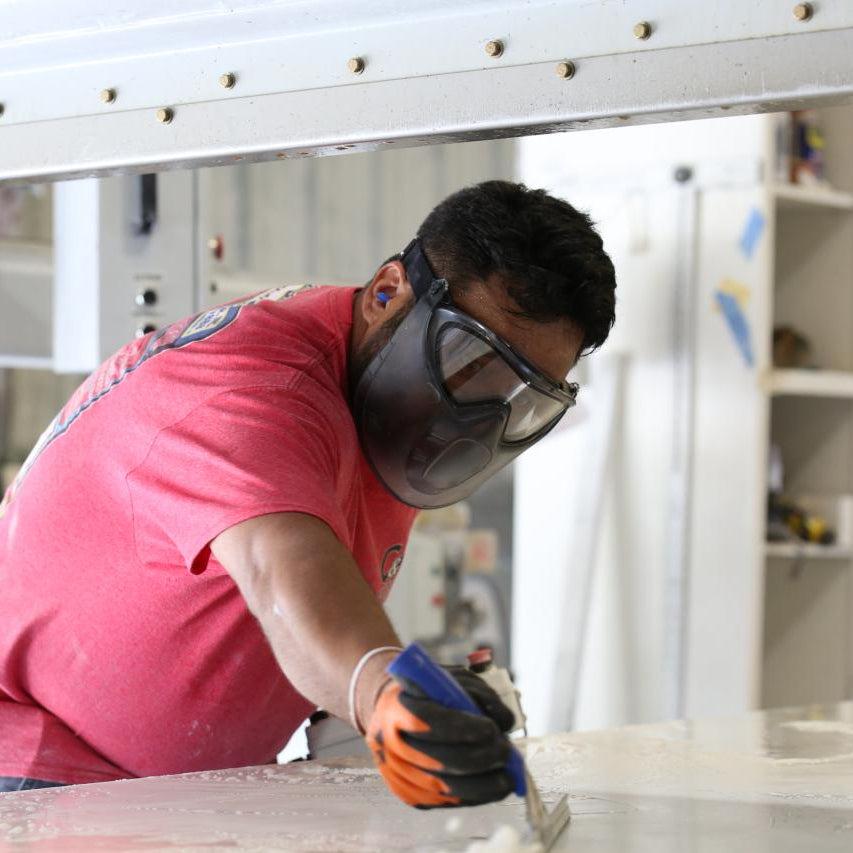 Worker wearing Pyramex GL504 Insulated Work Gloves wearing goggles and a face shield.