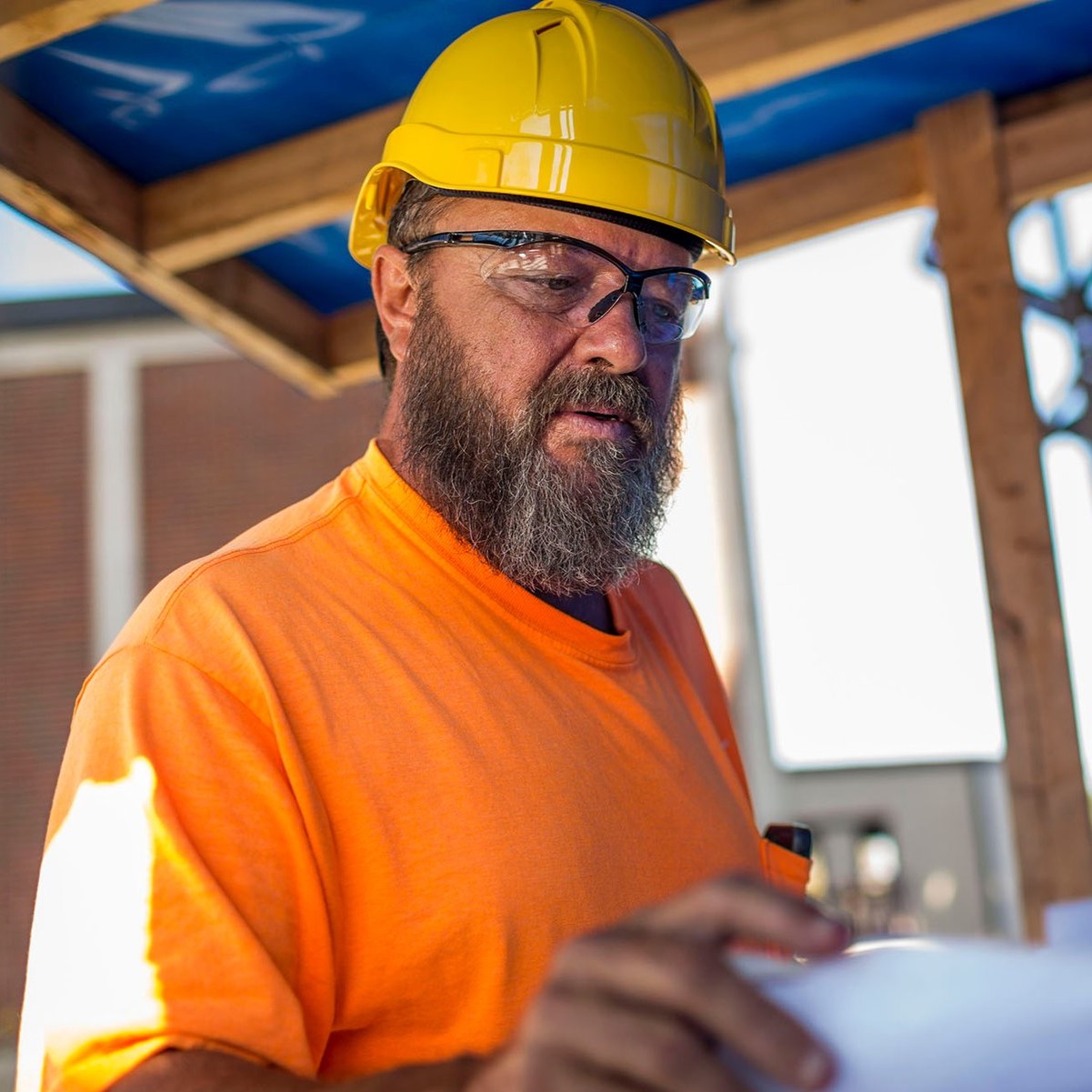 Pyramex PMXTREME Safety Glasses - Black Frame - Clear Anti-Fog Lens worn by a worker with a hard hat