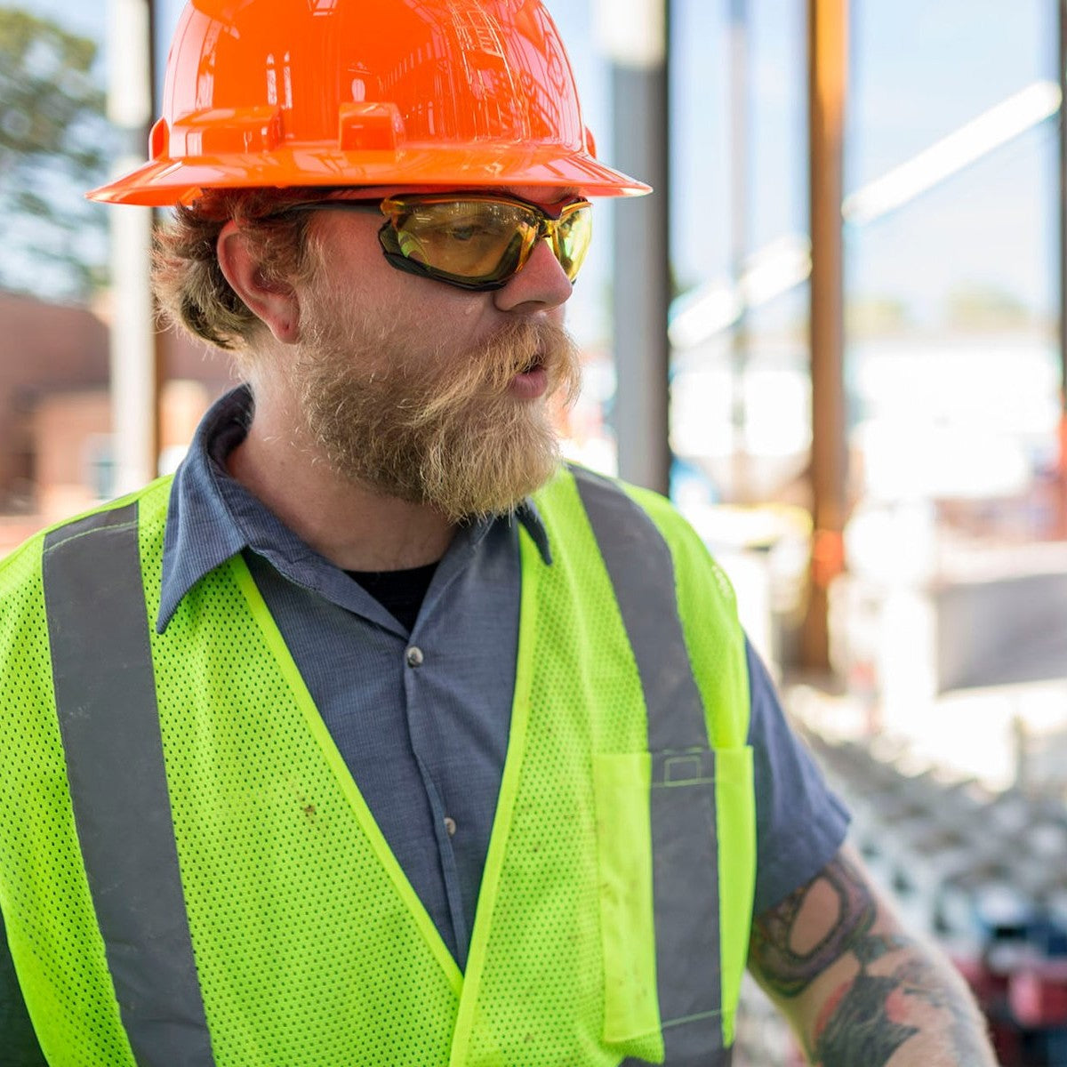Pyramex Proximity Safety Glasses with Black Frame and Amber Anti-Fog Lenses worn by construction worker