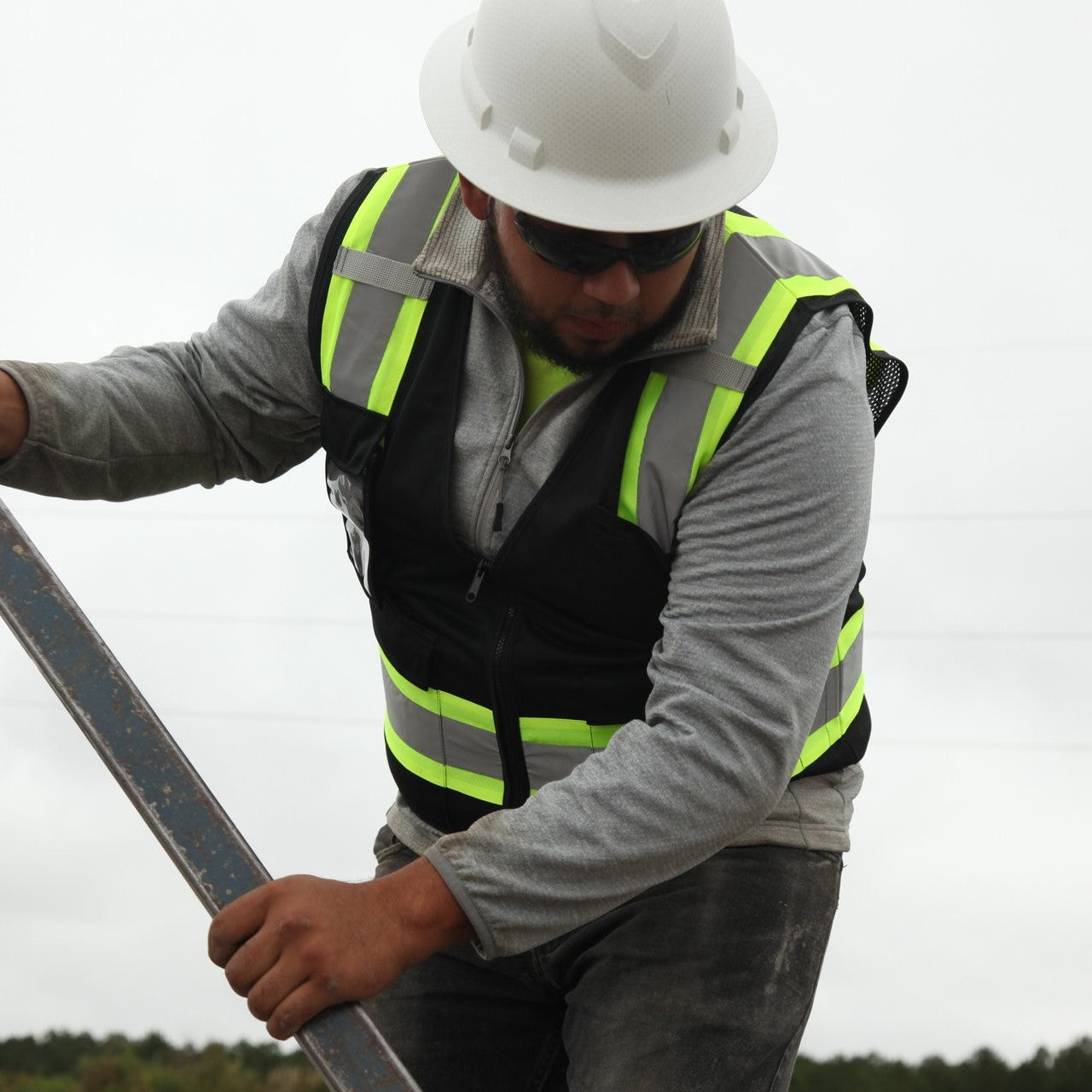 Pyramex RVZ2411CP Black Hi-Vis Safety Vest worn by road construction worker with hard hat