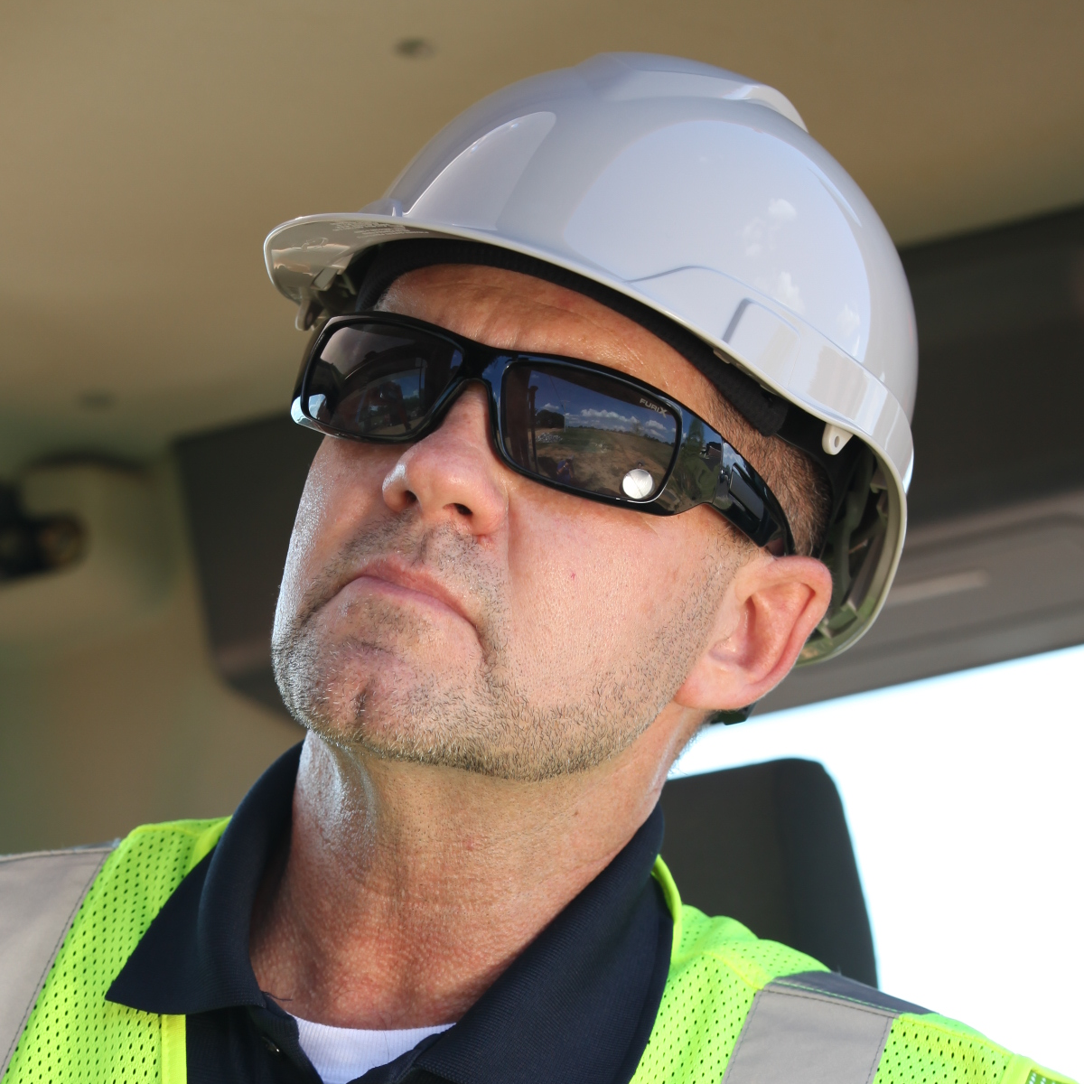 Pyramex HP44110 Ridgeline Cap Style Hard Hat worn by forklift driver with safety glasses