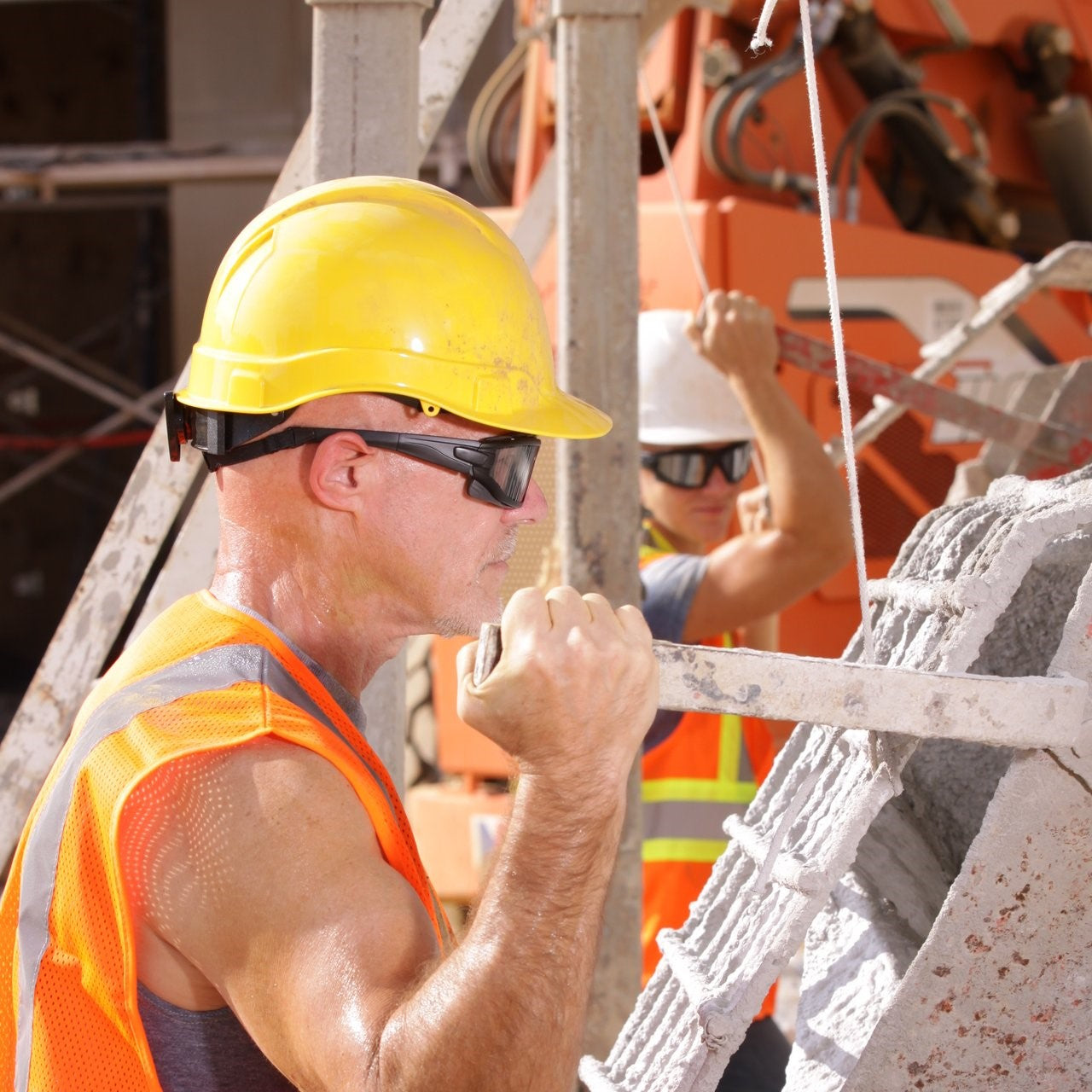 Pyramex Ridgeline Cap Style Hard Hat with 4-Point Ratchet Suspension Yellow worn by worker with safety glasses