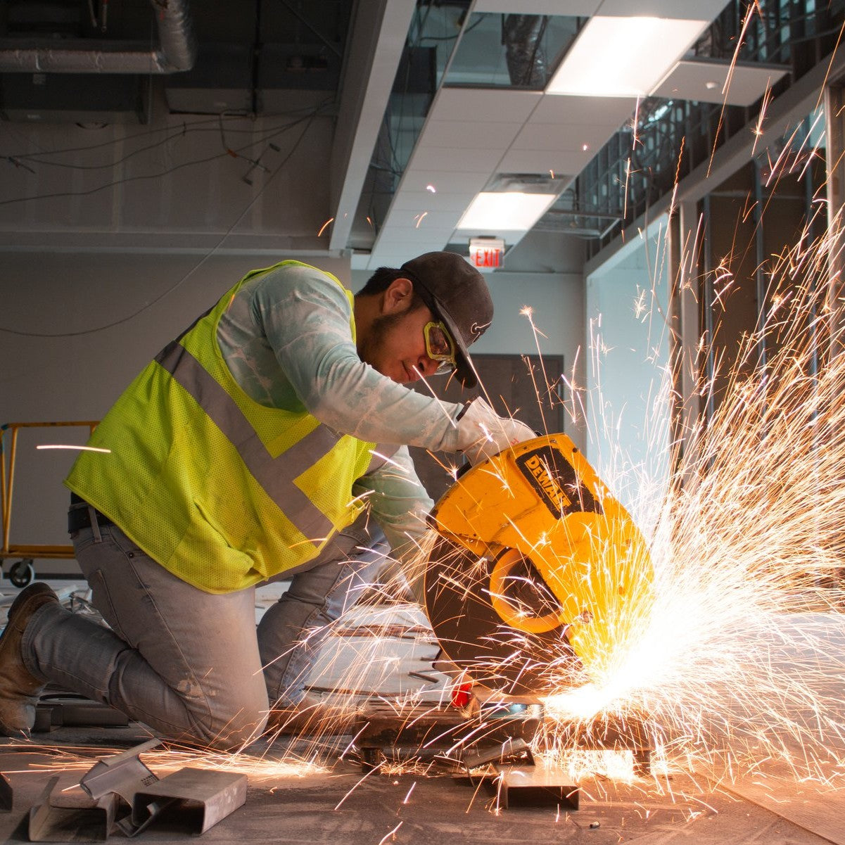 Pyramex SBL9310STM Proximity Safety Glasses - Black/Lime Foam Lined Frame - Clear H2MAX Anti-Fog Lenses worn by a construction worker using a saw