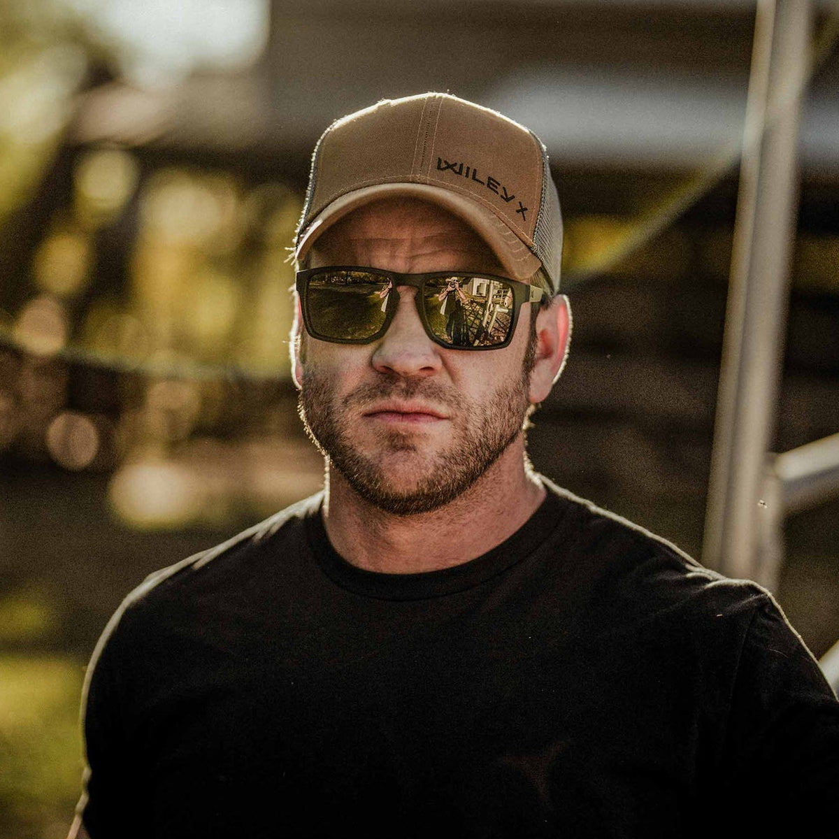 Man wearing Wiley X Founder Safety Glasses with Bronze Lenses and a Wiley X Tan Hat