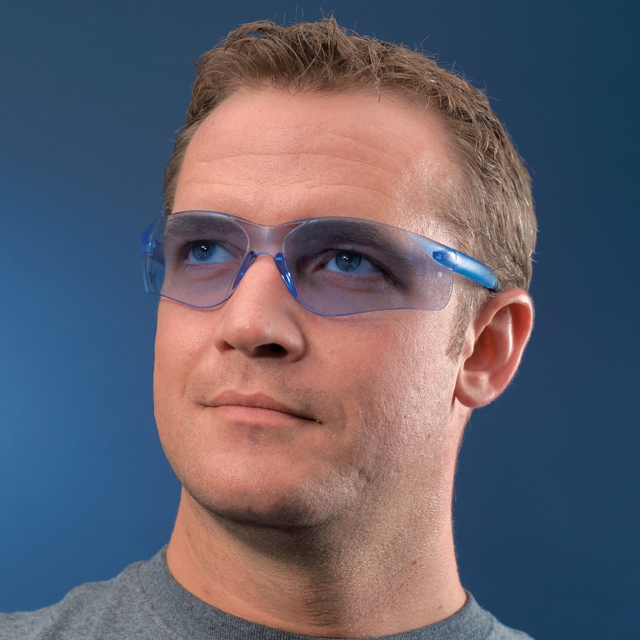 Man wearing MCR Safety BearKat BK1 Safety Glasses with Light Blue Lenses BK113