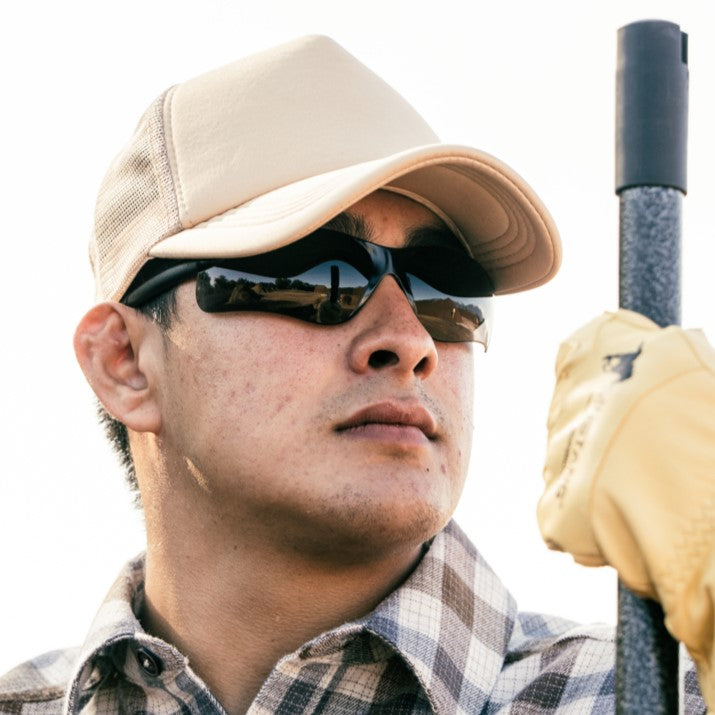 Worker wearing MCR Safety BK1 Safety Glasses wearing a hat