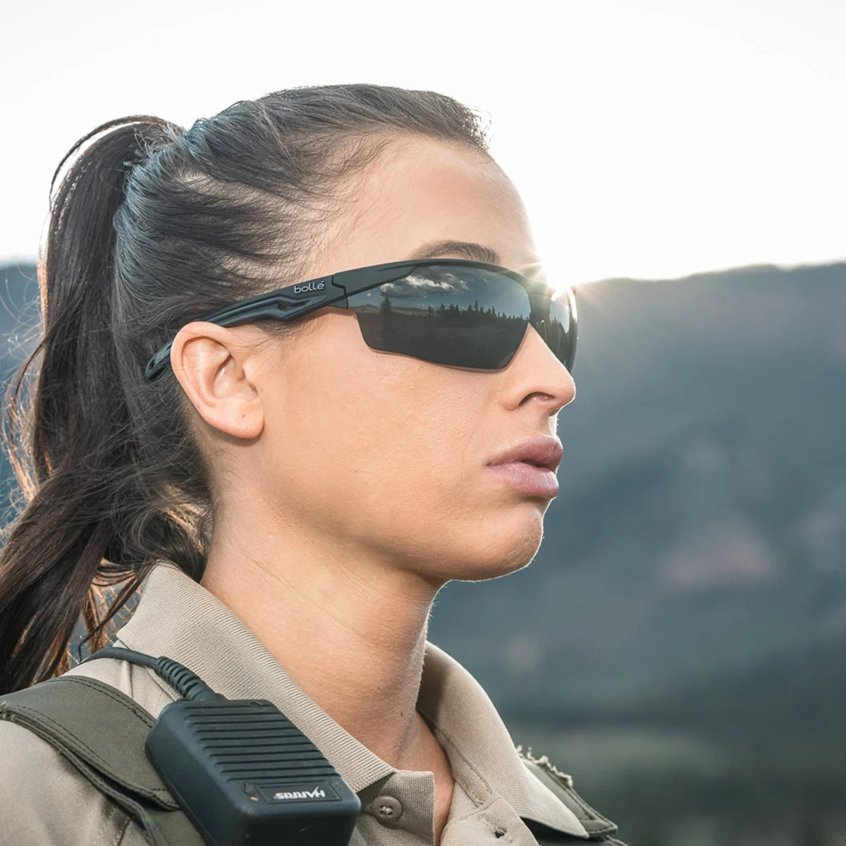 Bolle Tryon BSSI Ballistic Safety Glasses with Gray Lenses worn by a female LEO in the desert
