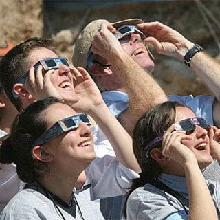 Eclipse Glasses ISO Certified Solar Eclipse Glasses worn by group during solar eclipse