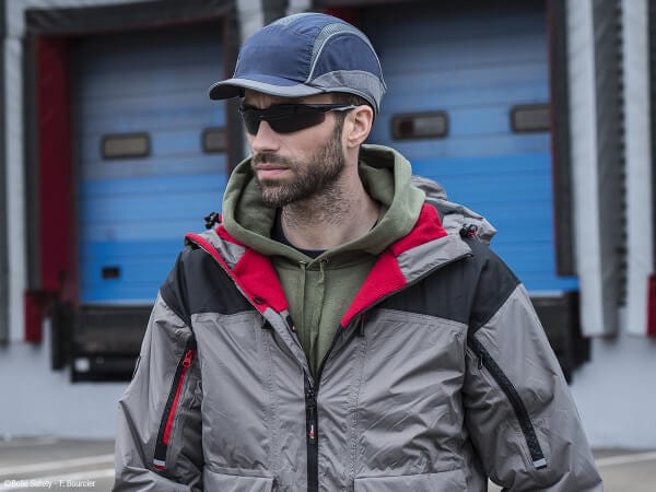 Man Wearing Bolle Iluka Safety Glasses with Black/Gray Temples and Smoke Anti-Fog Lens