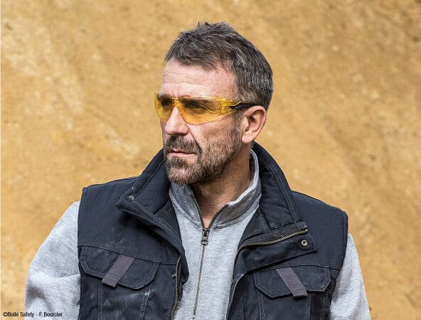 Man Wearing Bolle Silex Safety Glasses with Yellow/Black Temples and Yellow Anti-Fog Lens
