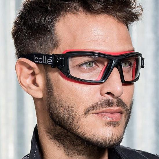Man Wearing Bolle ULTIM8 Safety Glasses/Goggle with Black/Red Temples, Foam Gasket and Clear Platinum Anti-Fog Lens