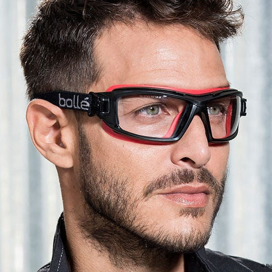 Man Wearing Bolle ULTIM8 Safety Glasses/Goggle with Black/Red Temples, Foam Gasket and Clear Platinum Anti-Fog Lens