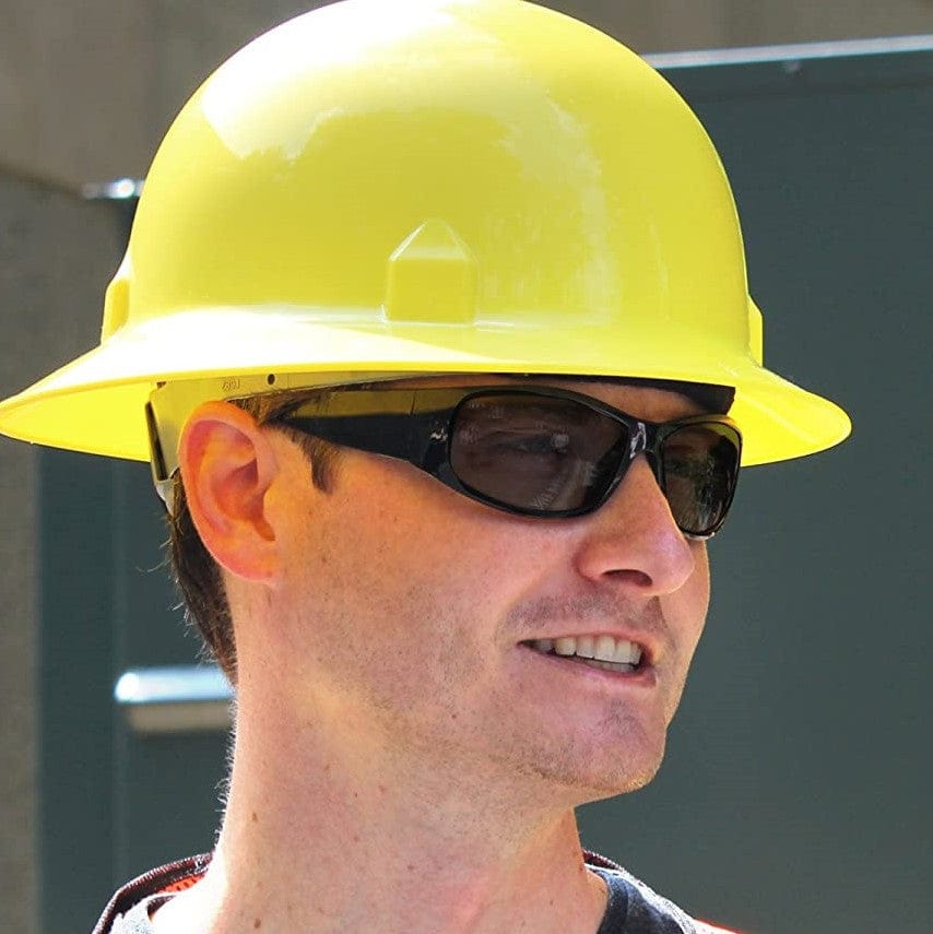 Smith & Wesson 21303 Elite Safety Glasses with Black Frame and Smoke Anti-Fog Lens worn with a yellow hard hat