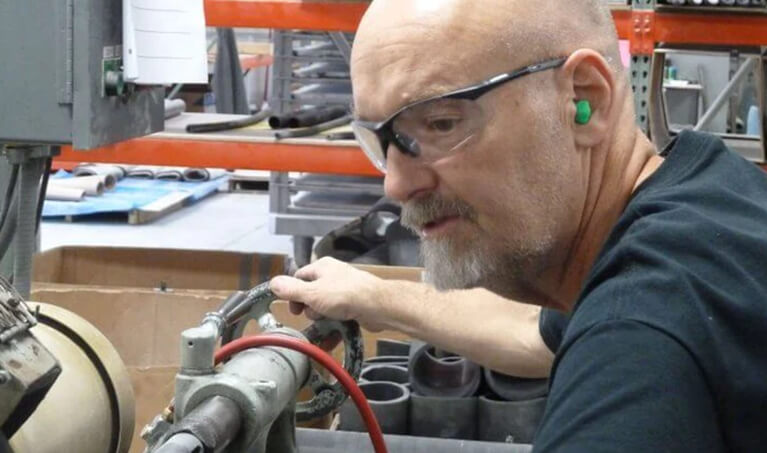 A worker wearing Delta Plus Rx-500 Safety Glasses