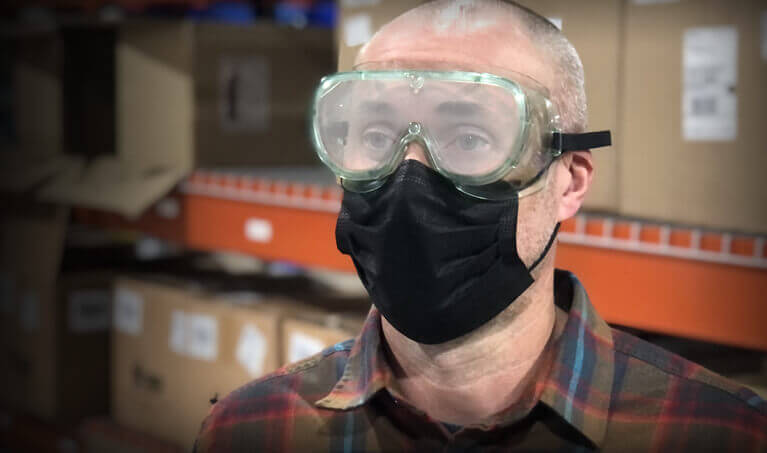 Worker wearing fogged up goggles with a face mask