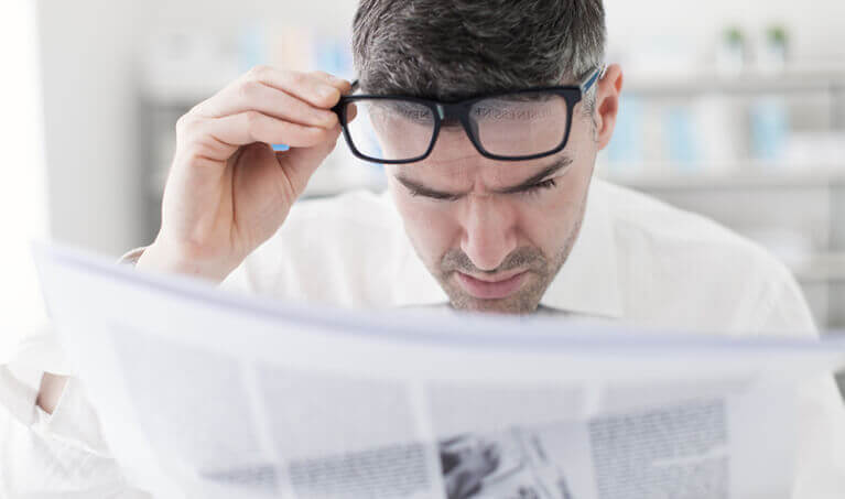 Office worker reading a news paper