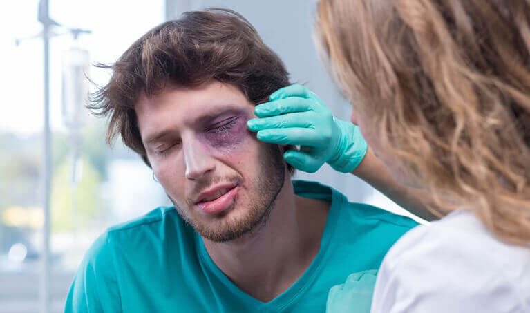 Man being treated for an eye injury