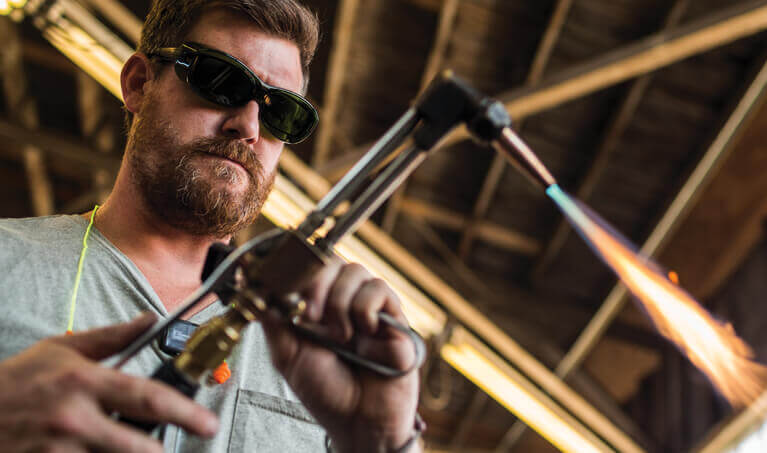 Worker wearing dark safety glasses