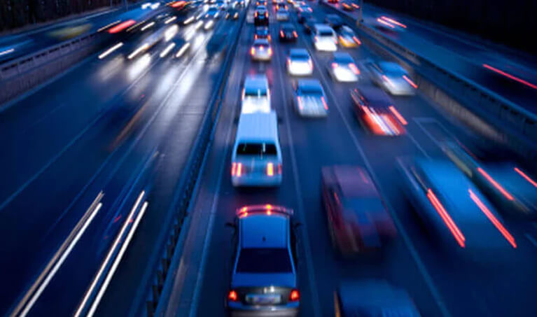 A busy highway at night with heavy traffic