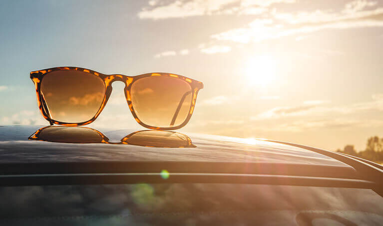Polarized Sunglasses sitting on the roof of a car