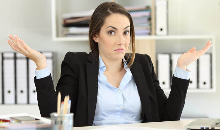 Woman shrugging her shoulders to a question