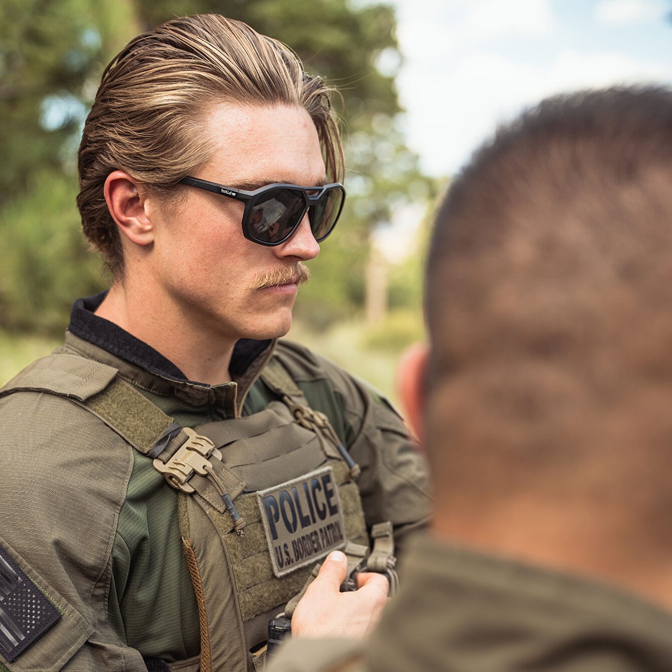 Bolle Altus Safety Glasses Black Frame with Smoke Lenses worn on duty