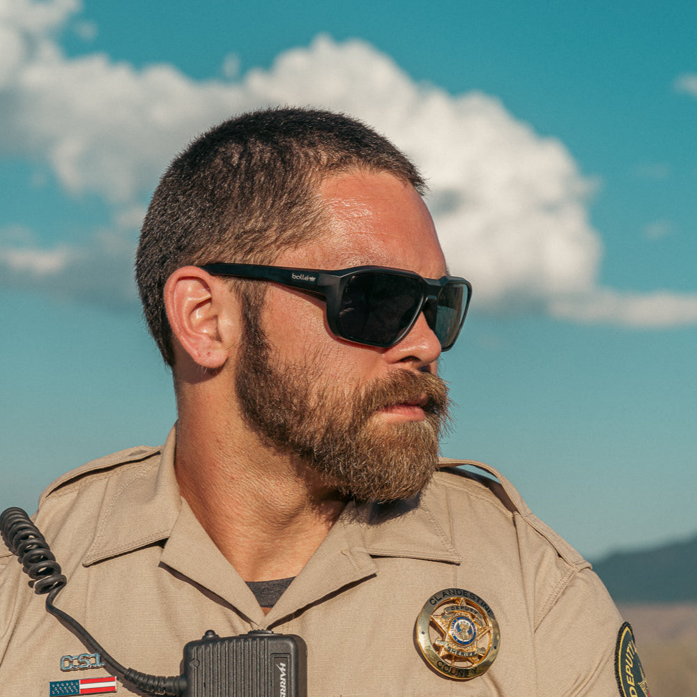 Bolle KNOXXT20M Knox Safety Glasses Black Frame with Polarized Smoke Anti-Fog Lenses worn on patrol