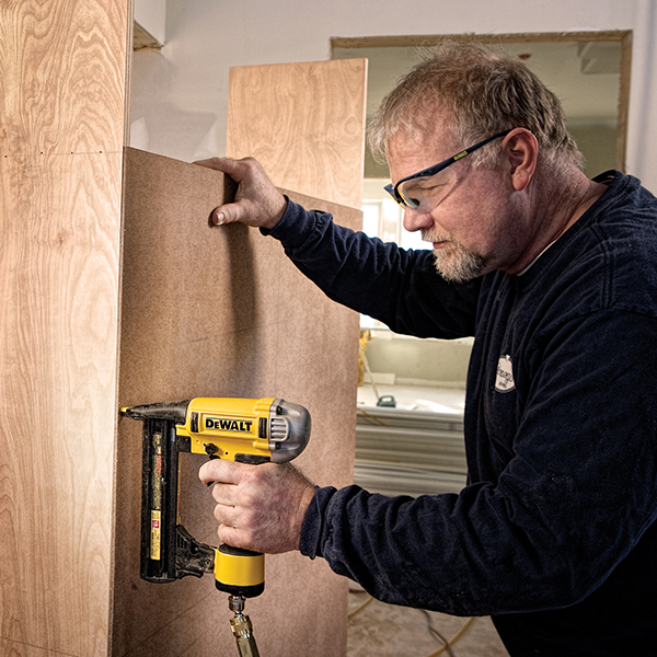 Worker wearing Dewalt DPG59-1 Reinforcer Rx Safety Glasses with Clear Lenses