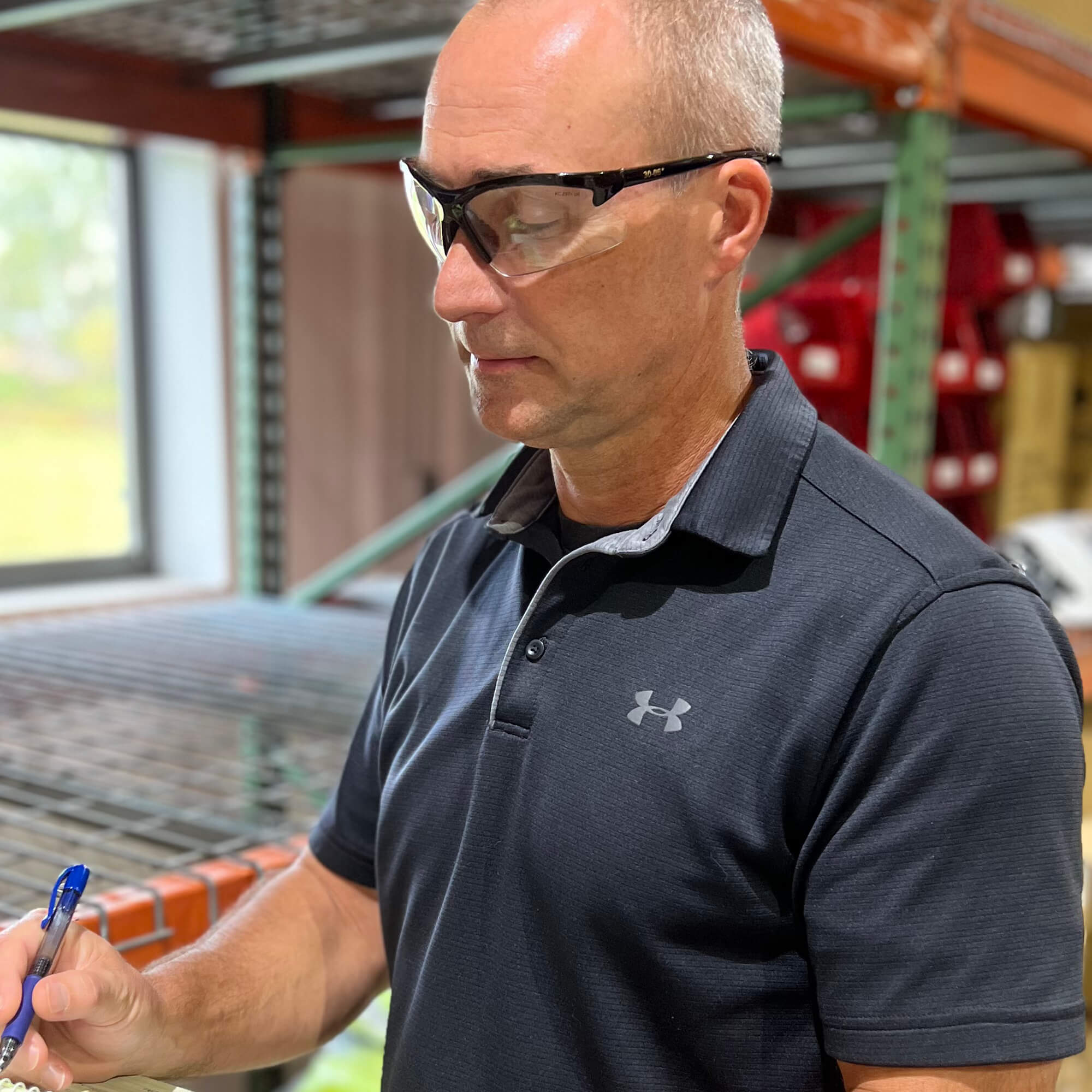 Warehouse worker wearing KleenGuard 30-06 Dual Readers Safety Glasses With Clear Lenses