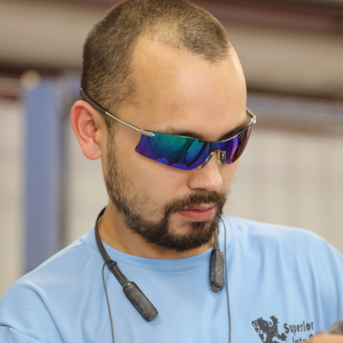 MCR Safety T411G Rubicon T4 Safety Glasses with Emerald Mirror Lens worn by worker 2