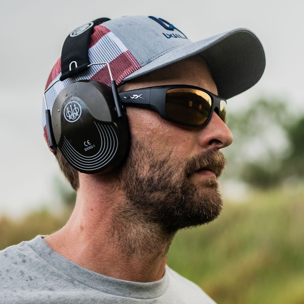 Man wearing Wiley X Omega Sunglasses with earmuffs