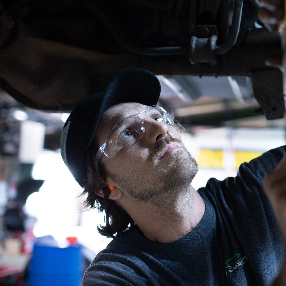 Pyramex Ztek Bifocal Safety Glasses with Clear Lenses worn by a mechanic