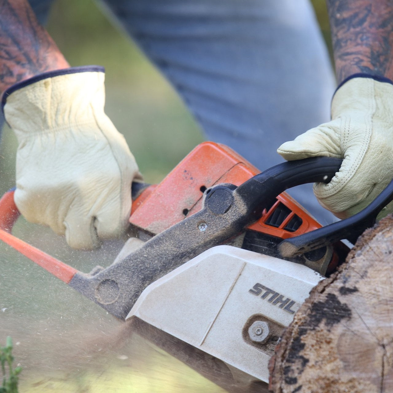 Pyramex GL2004K Grain Cowhide Leather Keystone Thumb Driver Gloves worn by worker sawing a tree