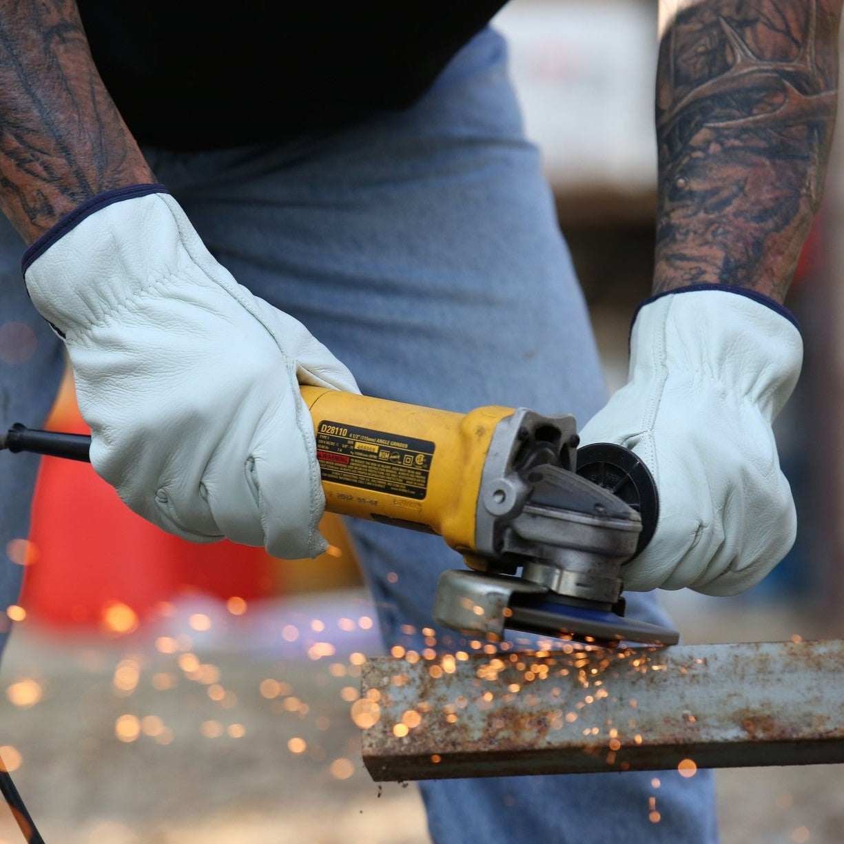 Pyramex GL2004K Grain Cowhide Leather Keystone Thumb Driver Gloves worn by worker grinding metal