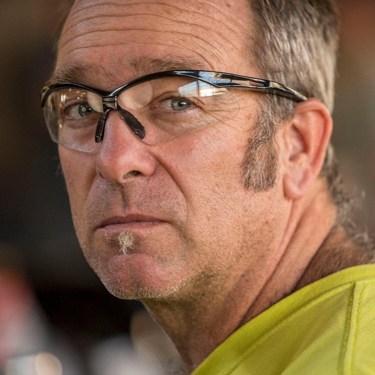 Pyramex PMXTREME Safety Glasses Black Frame Clear Lens worn by worker