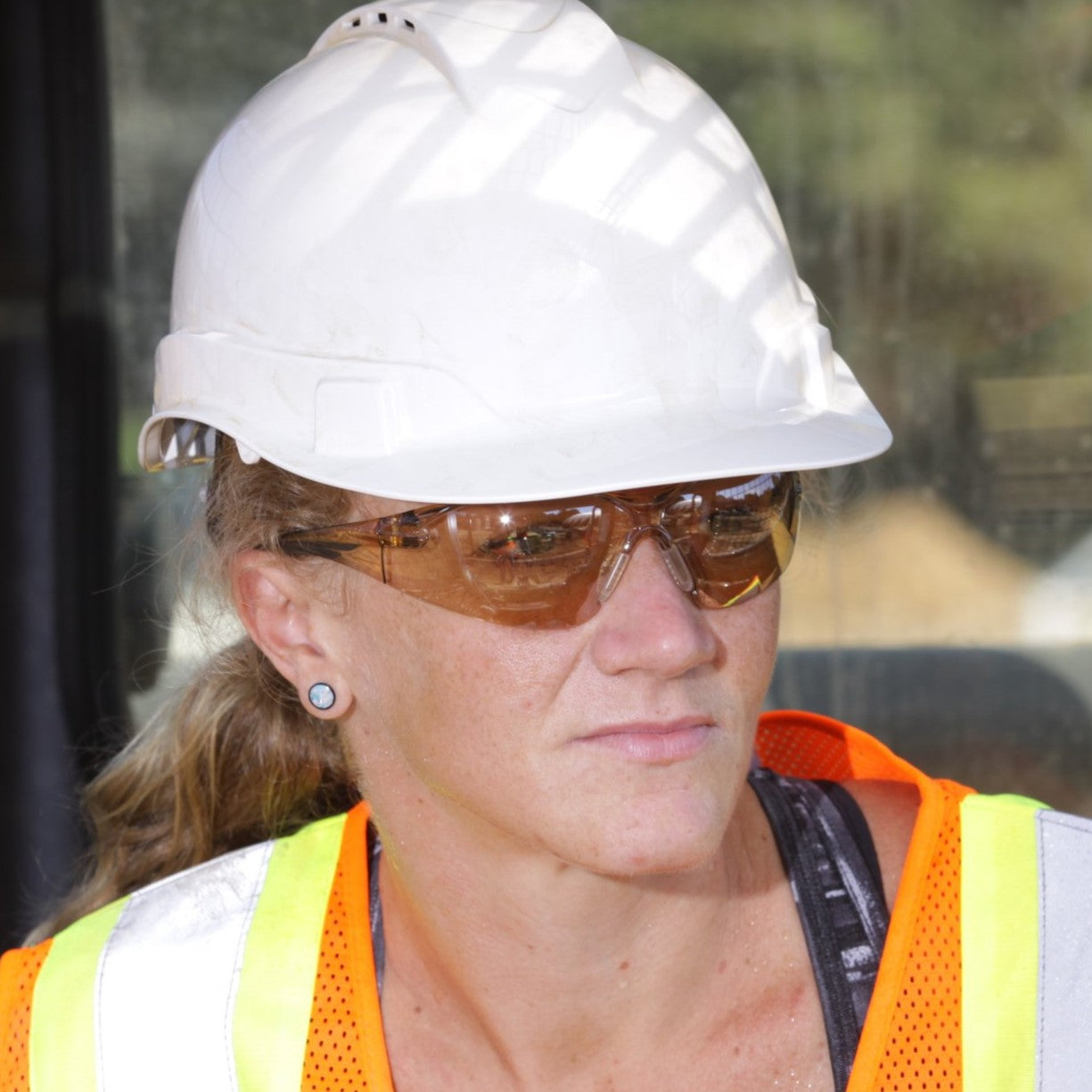 Pyramex SB7138S PMXSLIM Safety Glasses Black Temples Sandstone Bronze Lens worn by worker wearing a white hard hat