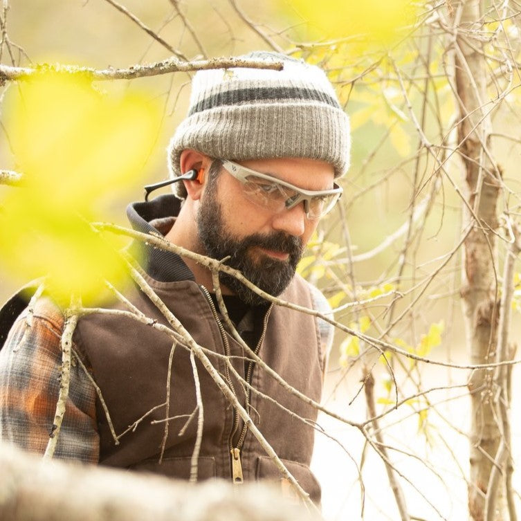 Woodsman wearing Venture Gear Semtex 2.0 Safety Glasses while walking in the woods