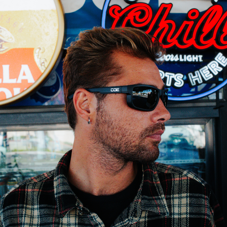 CO Eyewear Magneto Z87+ safety glasses with matte black frame, worn by a man in a plaid shirt.