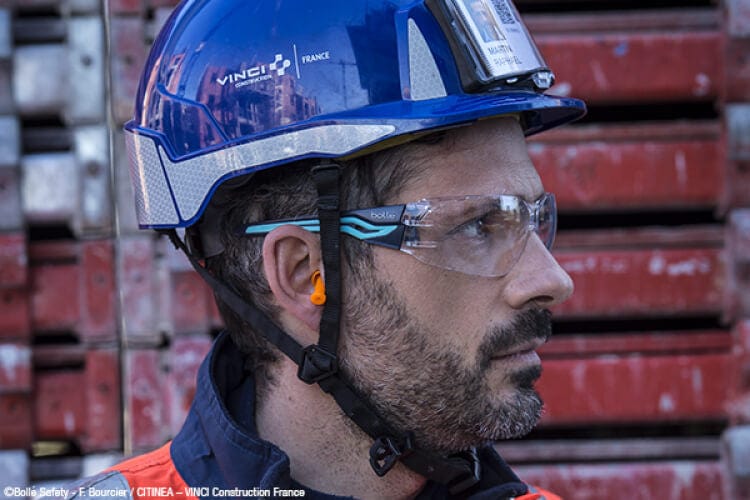 Man Wearing Bolle Silex Safety Glasses with Navy/Sky Blue Temples and Clear Anti-Fog Lens